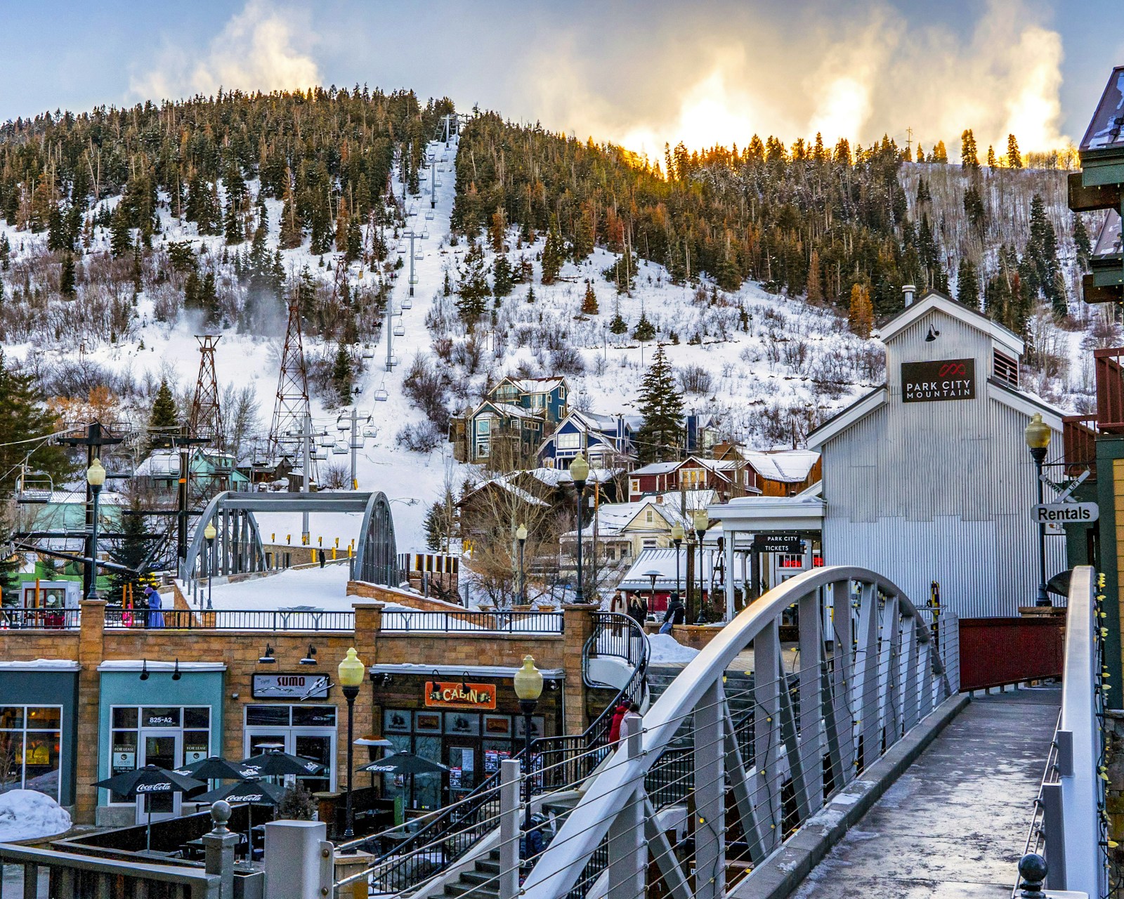 Downtown Park City buildings beneath snow-covered ski slopes