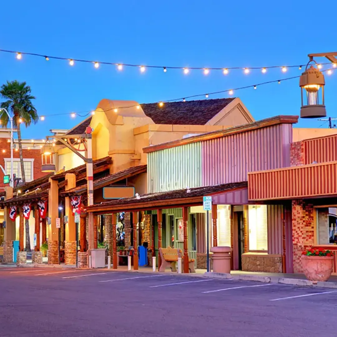 Downtown Scottsdale shops beneath string lights at dusk