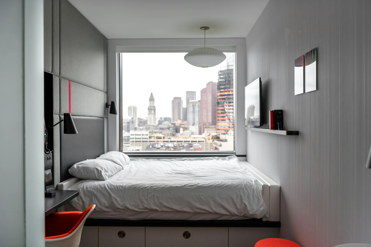 Minimalist bedroom overlooking a city skyline