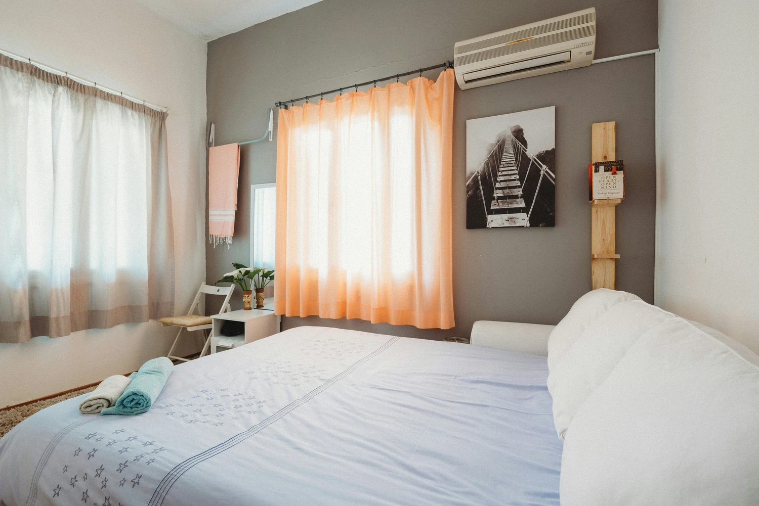 Bright bedroom with white bedding and warm wood accents
