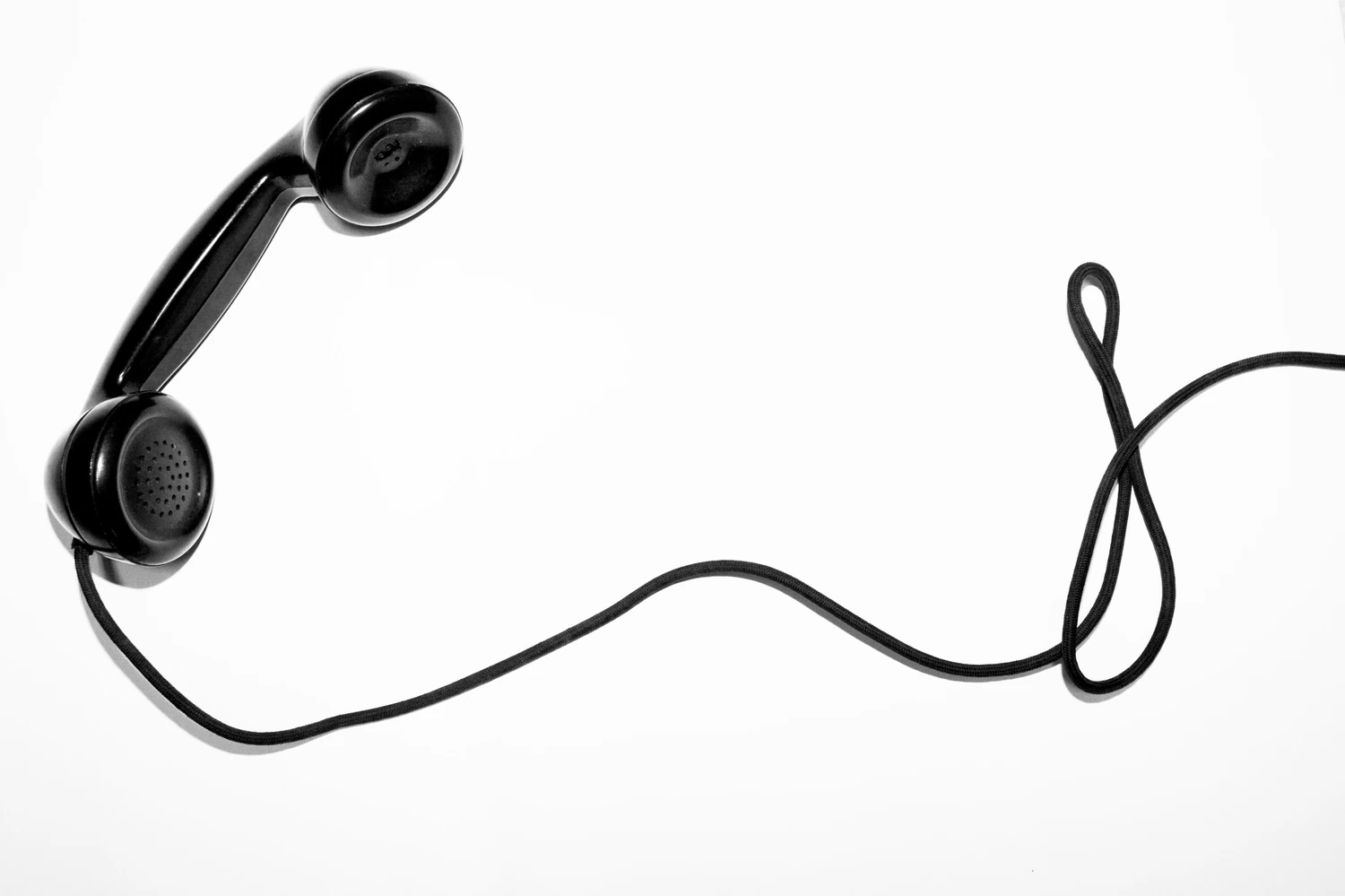 Black corded telephone handset on a white background