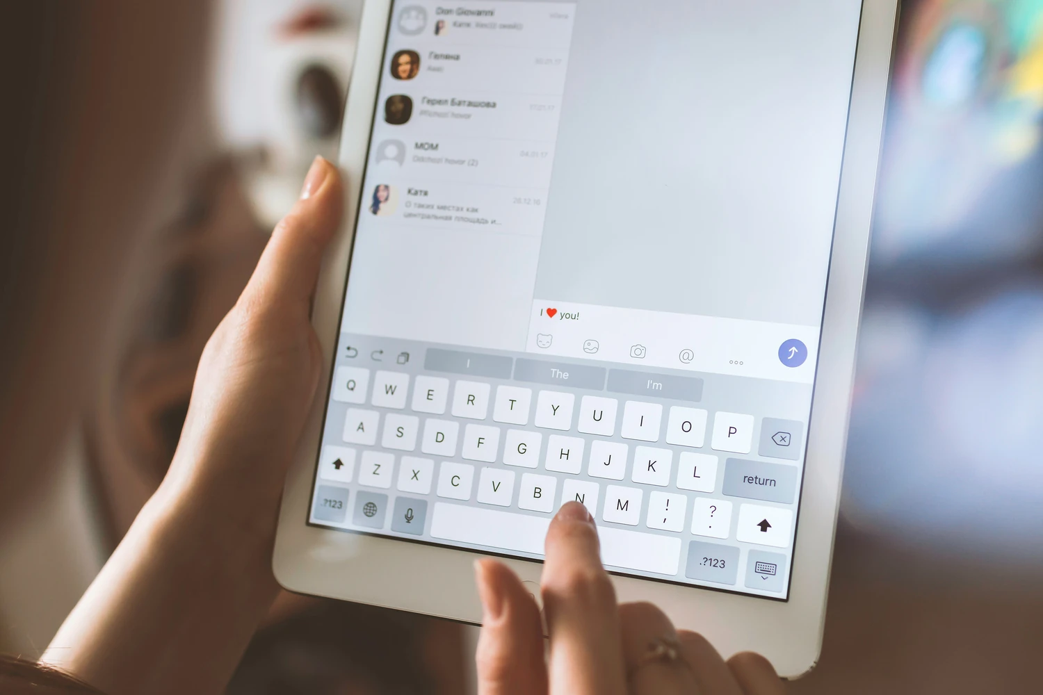 Person composing a message on a tablet