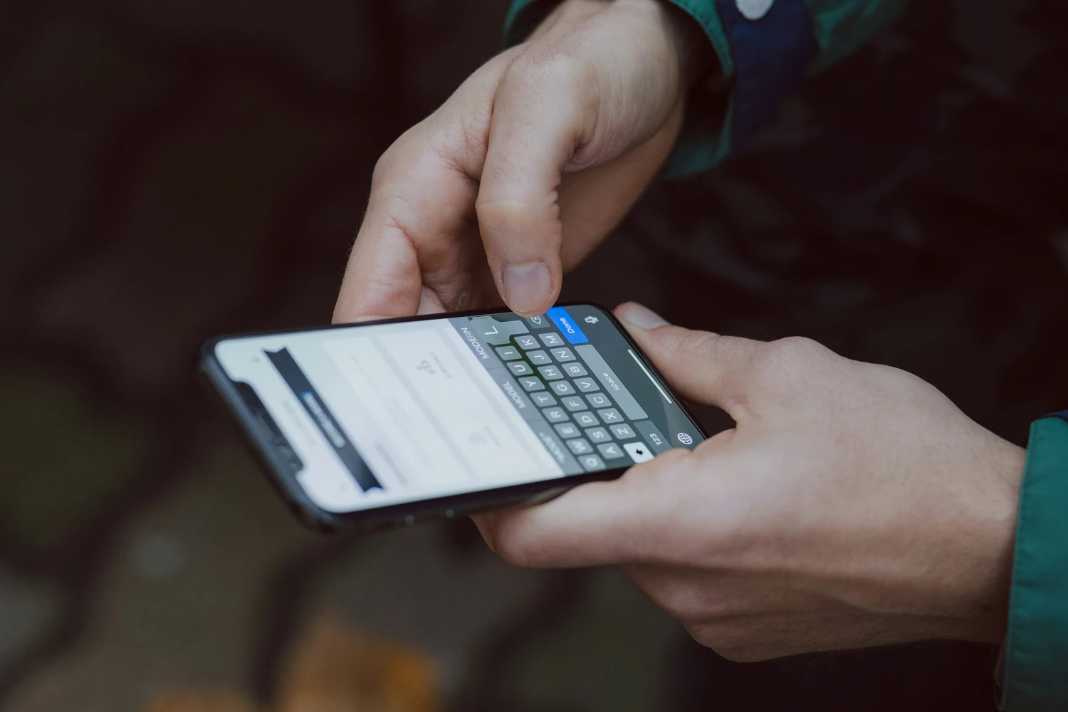Person entering information on a smartphone keypad