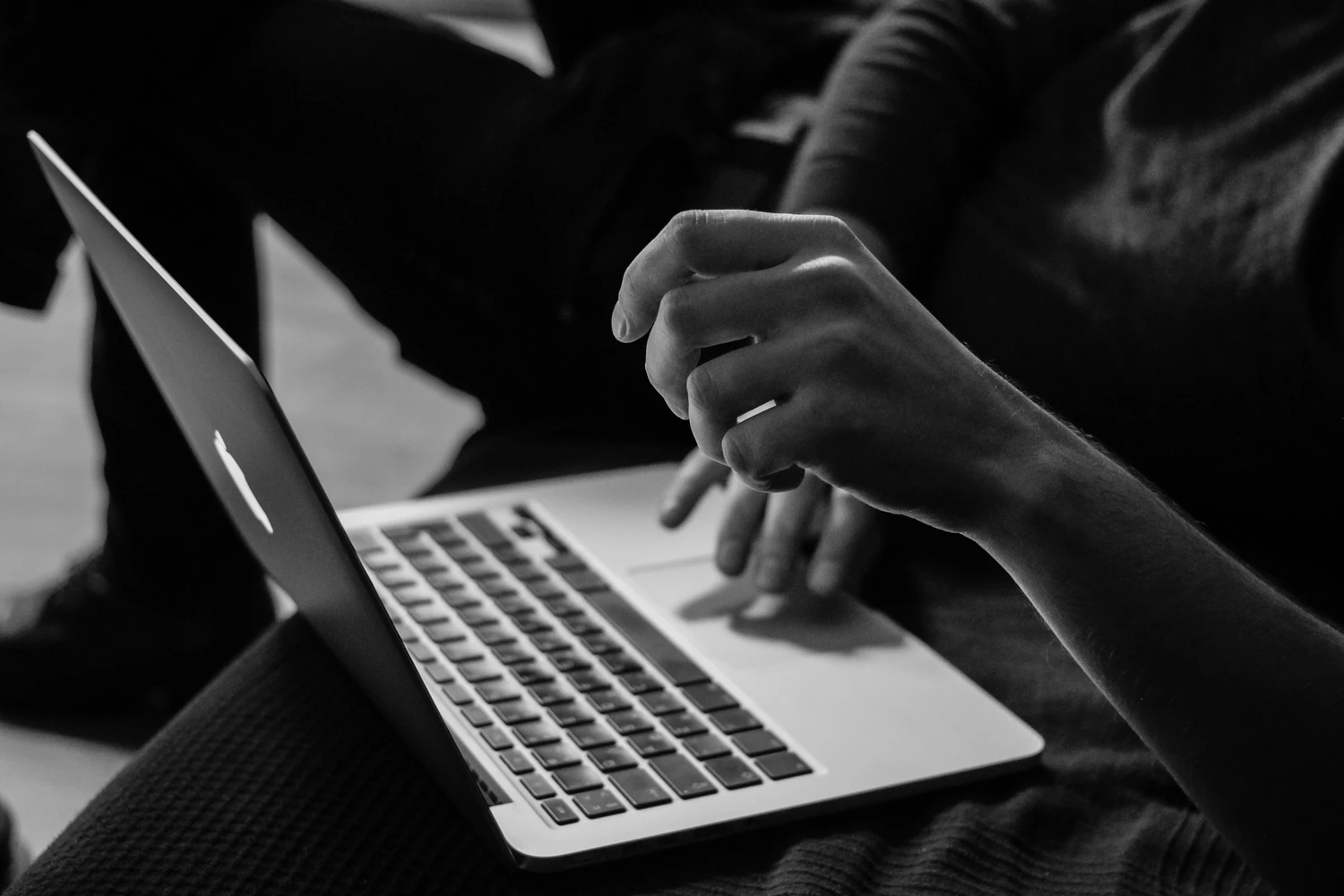 Person using a laptop in a dark room