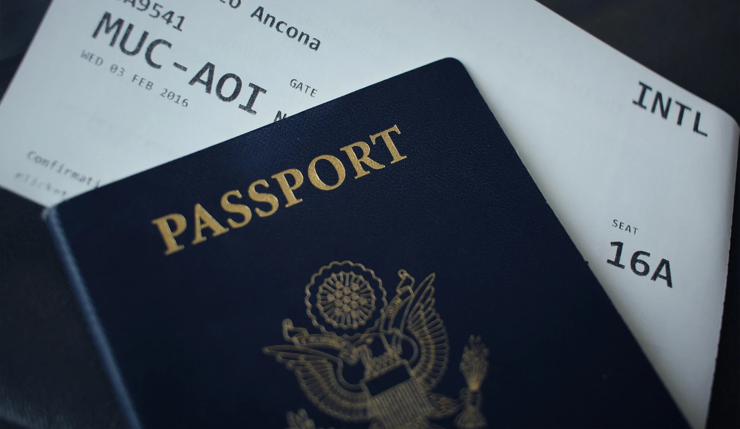 United States passport resting on international travel documents