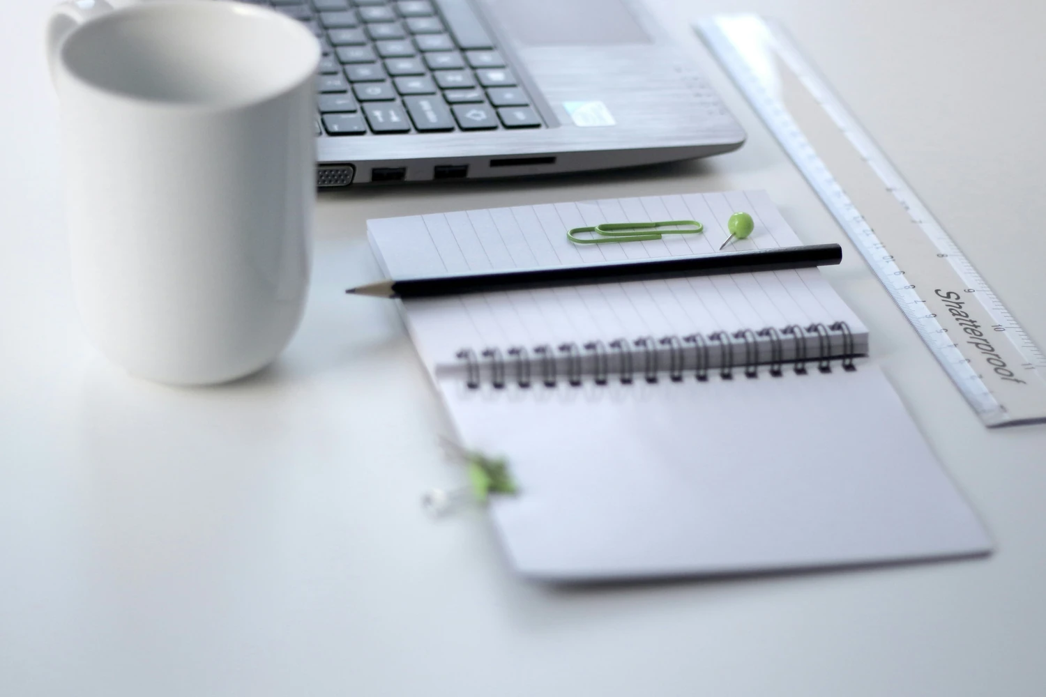 Budget worksheet, notebook, calculator, and coffee on a desk