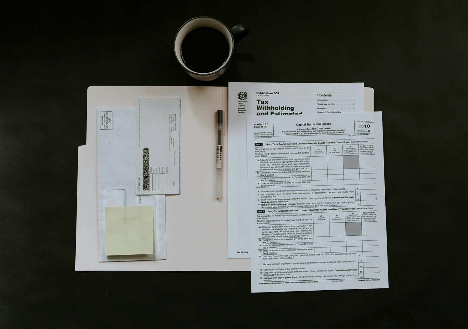 Financial documents and receipts arranged beside a cup of coffee