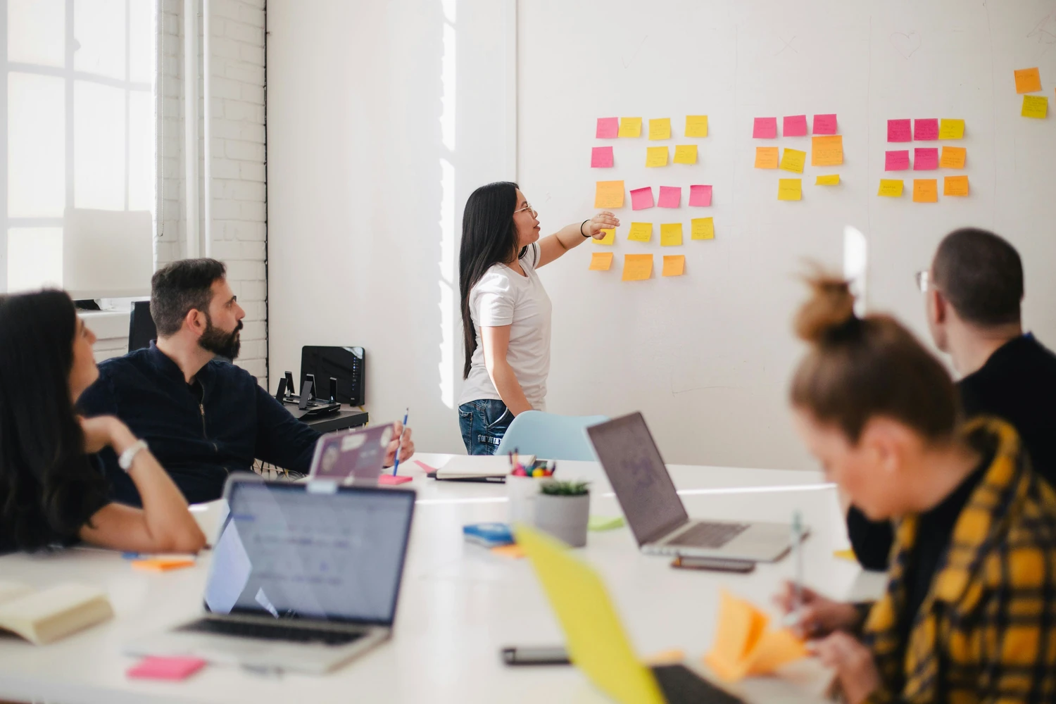 Team organizing colorful sticky notes during a planning session