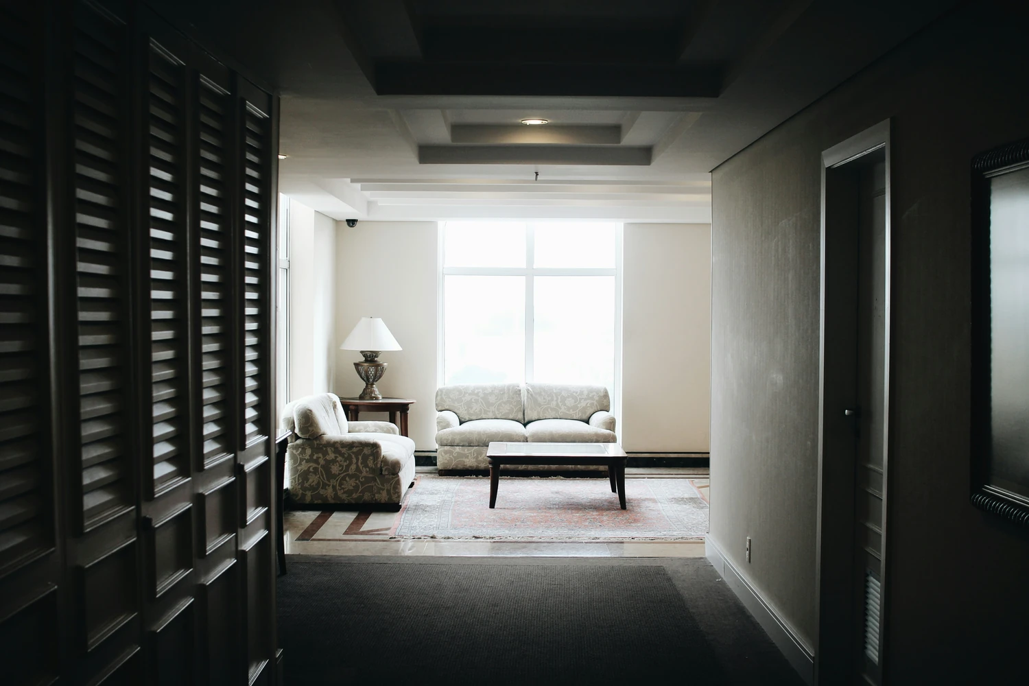 Hallway leading to a furnished living room